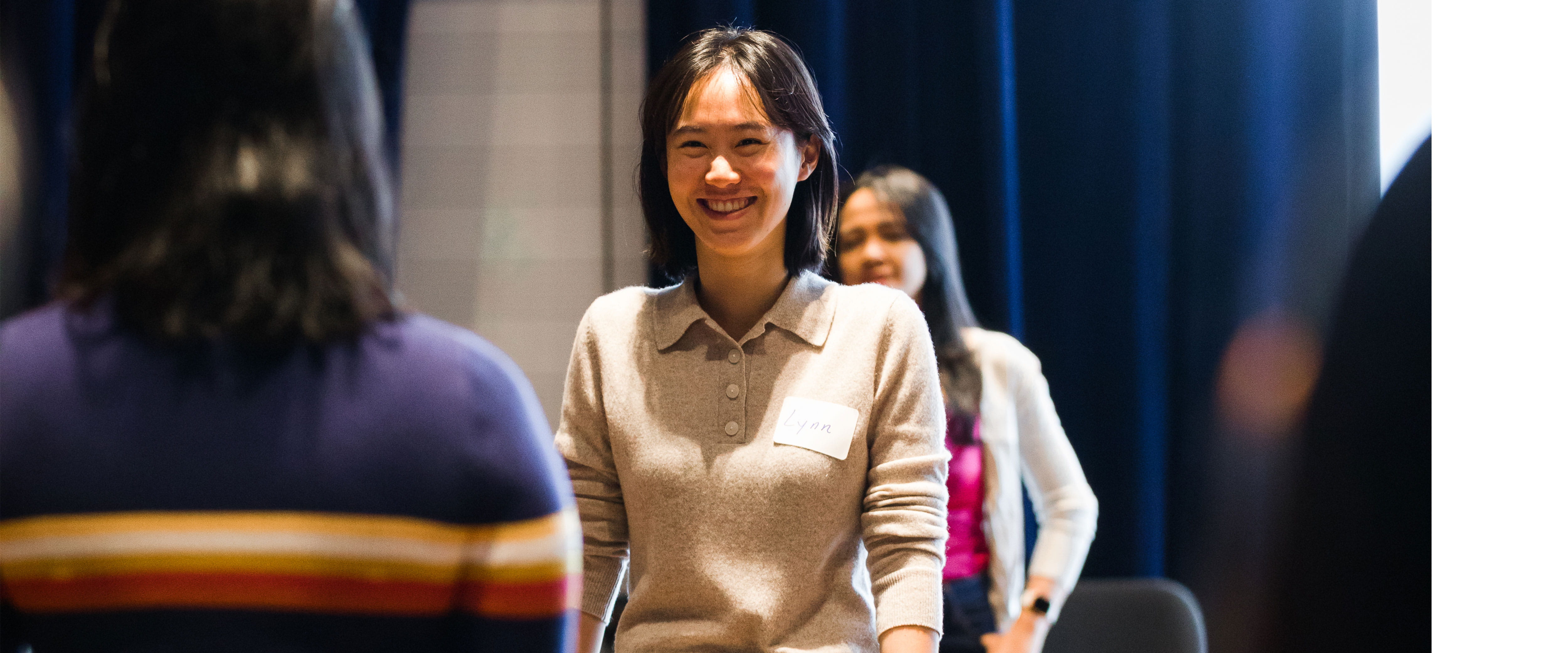 students at Booth Women Advance event standing 