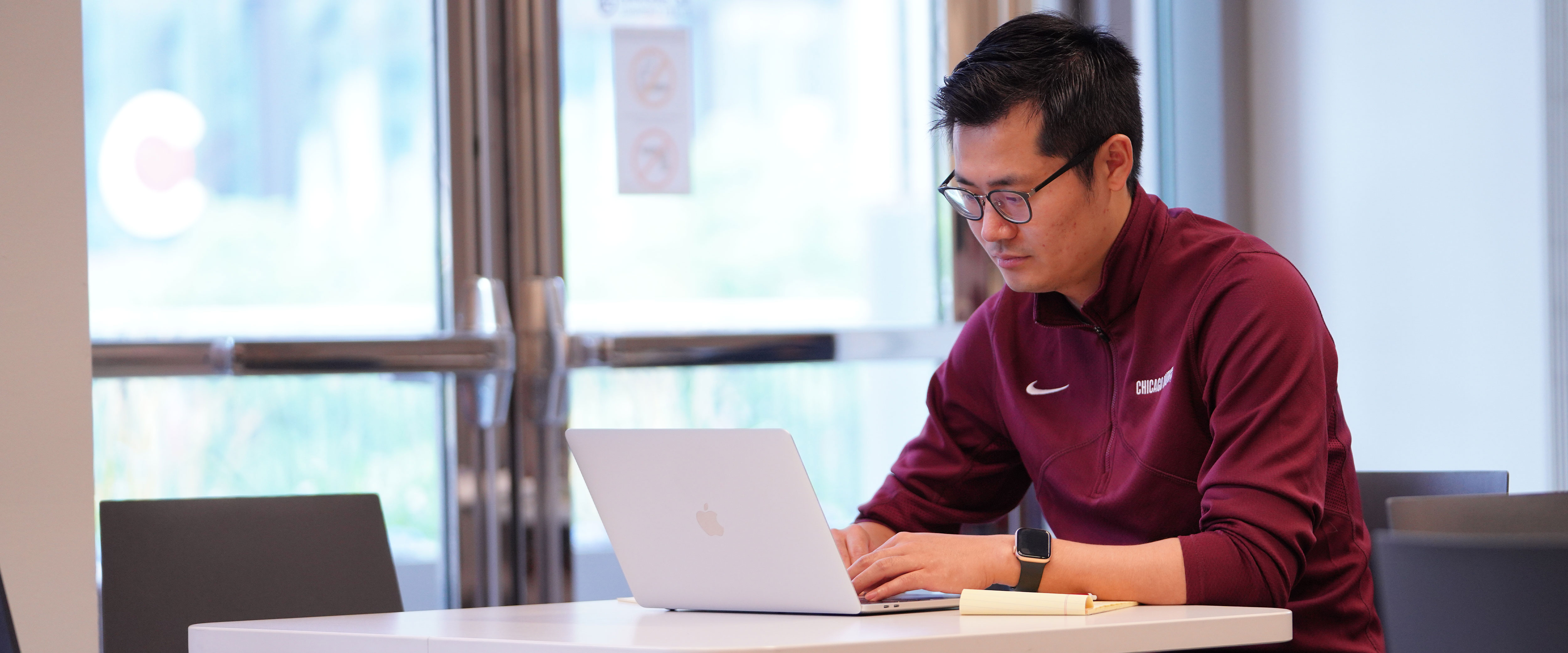 Guy sitting at table on laptop