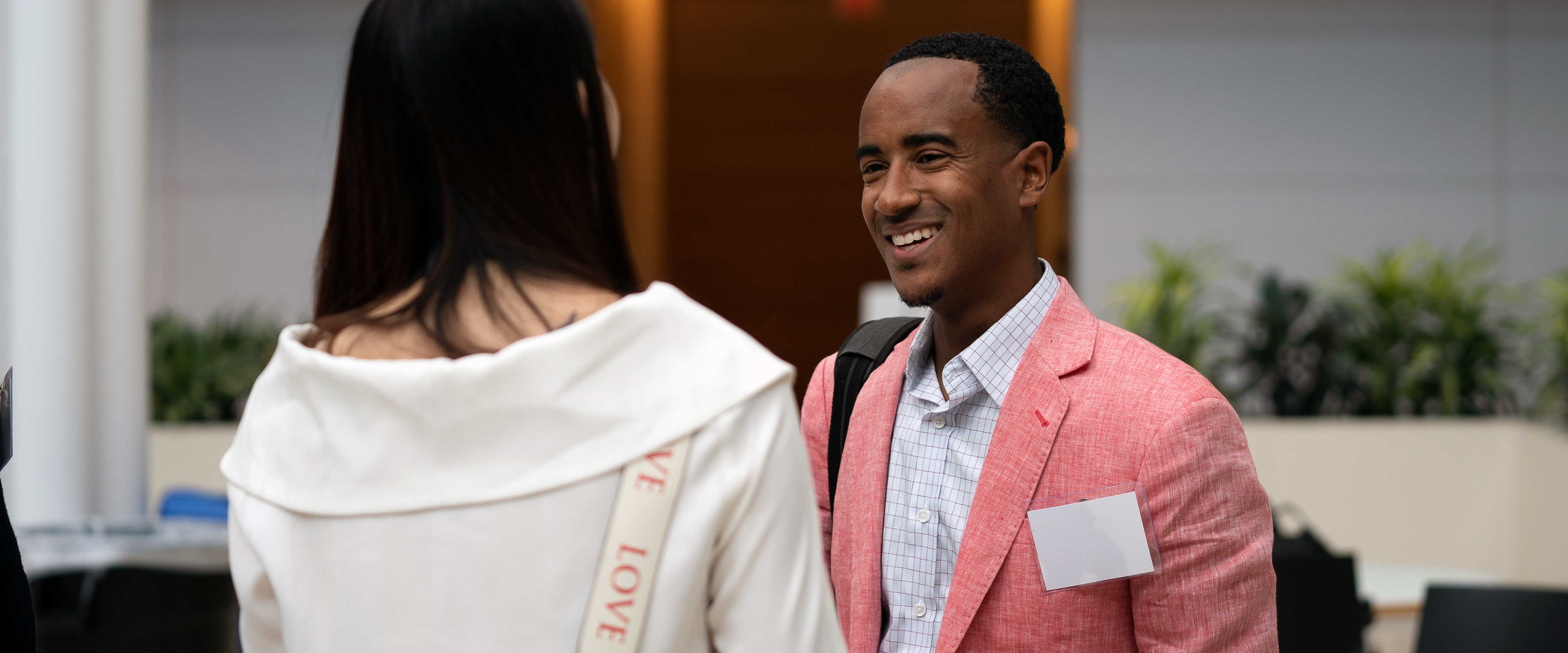 Juan Bell speaking with a woman in the winter garden