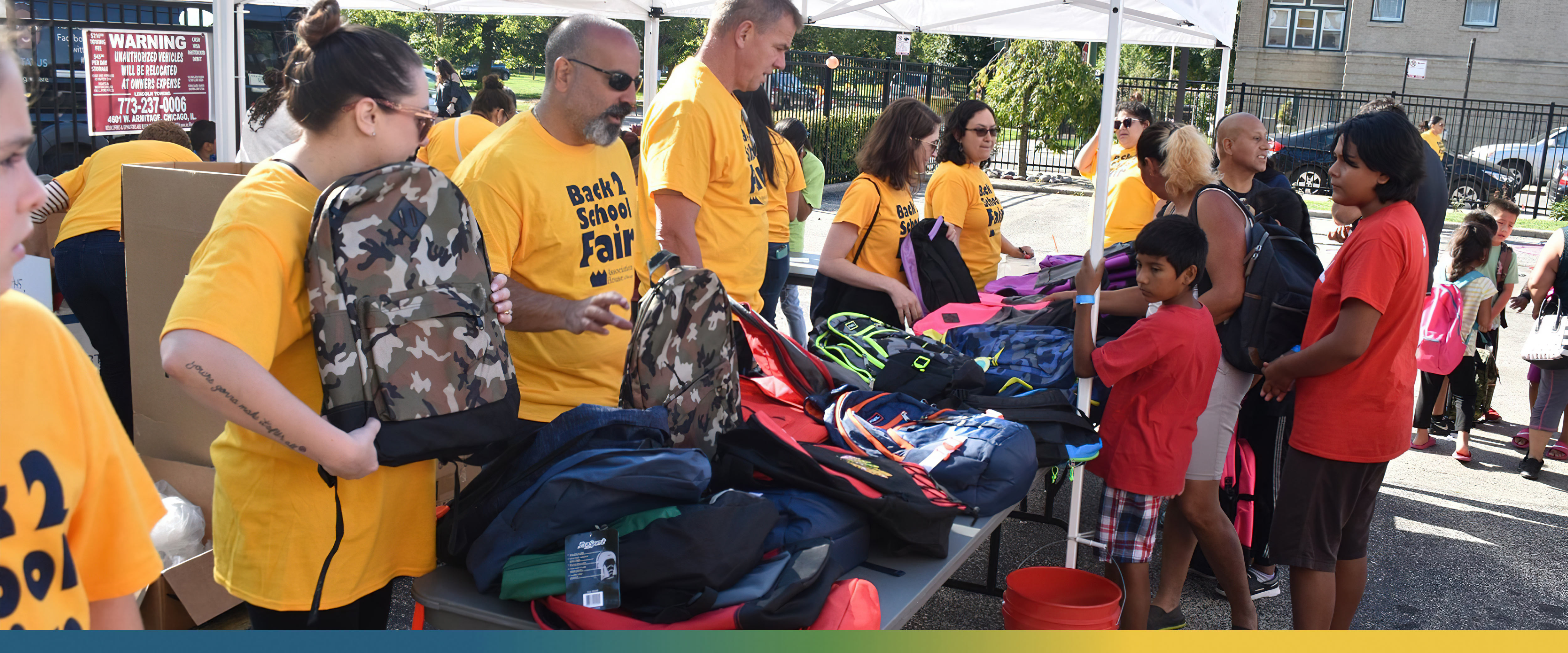 Volunteers at an event giving away school supplies