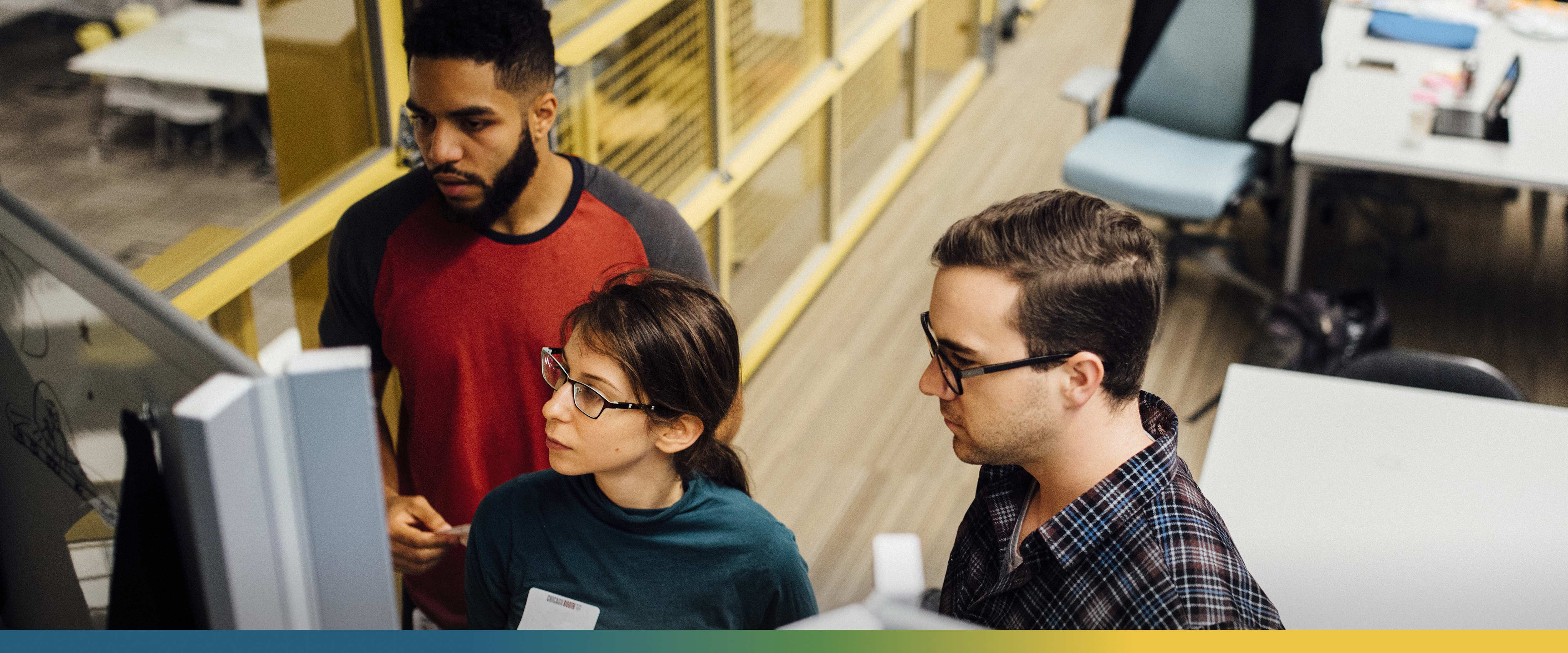 A group of students solving a problem at a dry erase board during OpenImpact