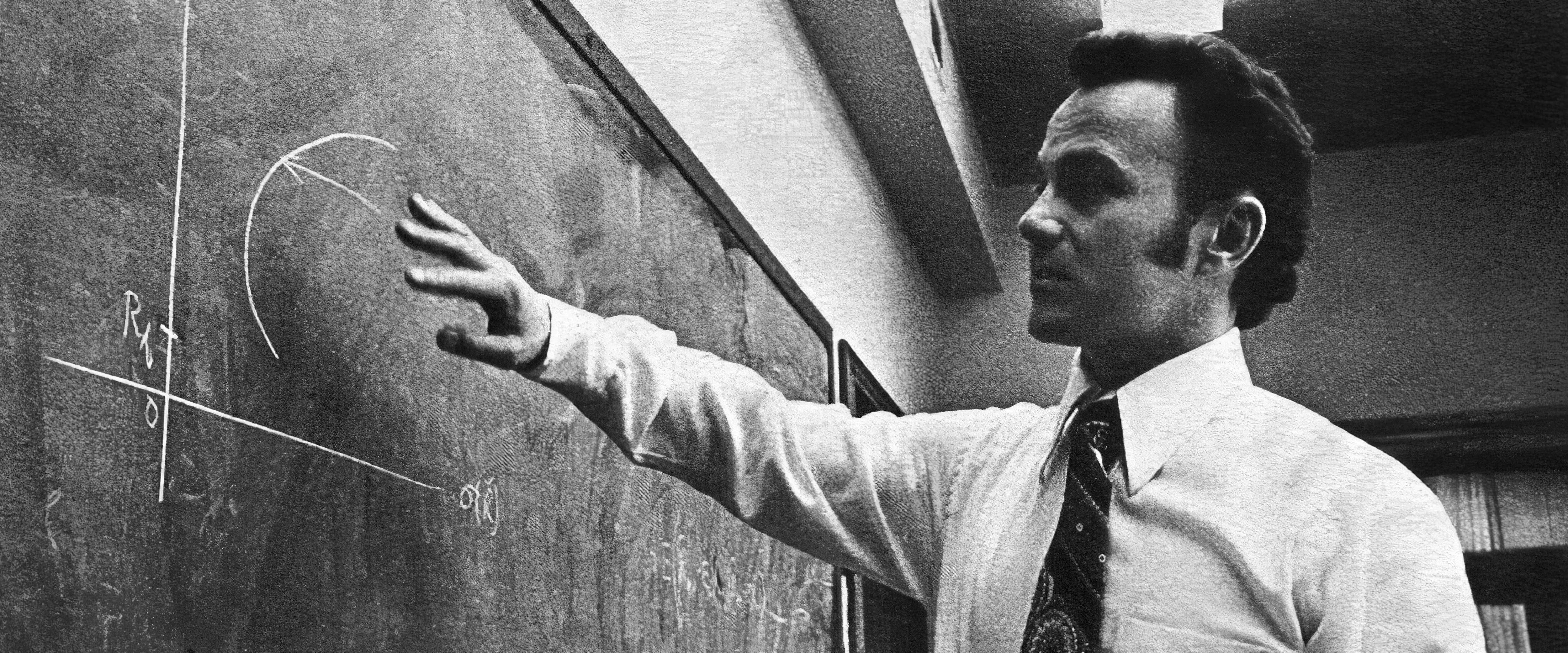 Eugene Fama teaches at a blackboard