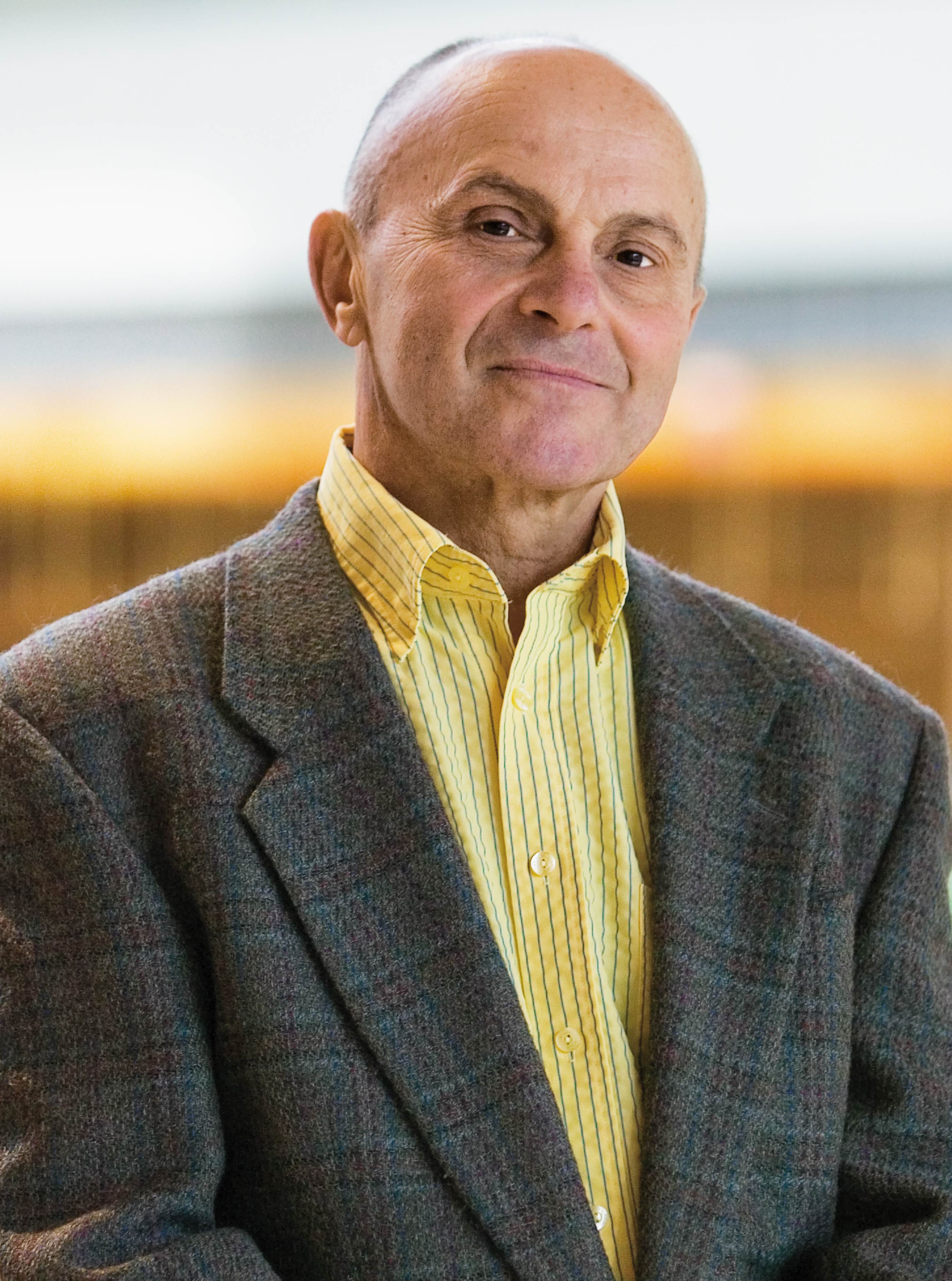 A headshot of Eugene Fama in a sunny atrium
