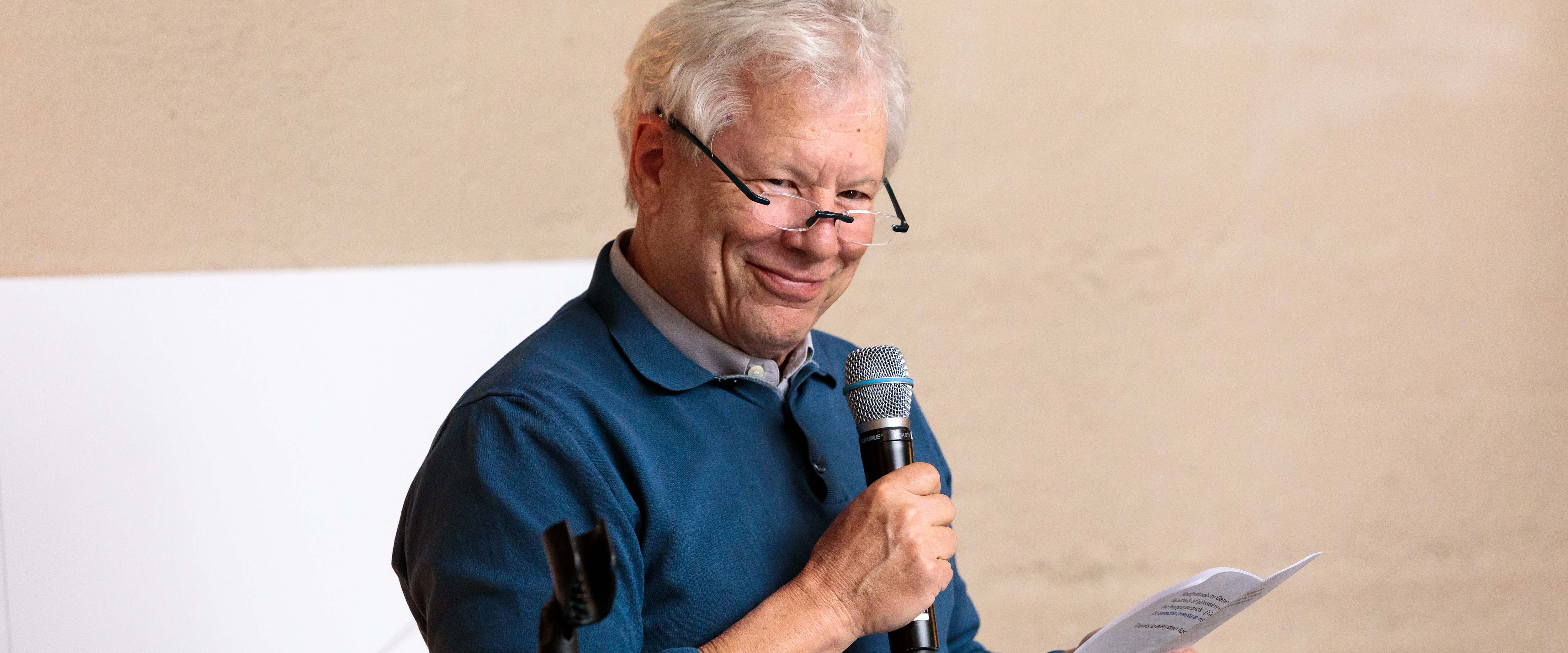 Richard Thaler standing and speaking into a microphone