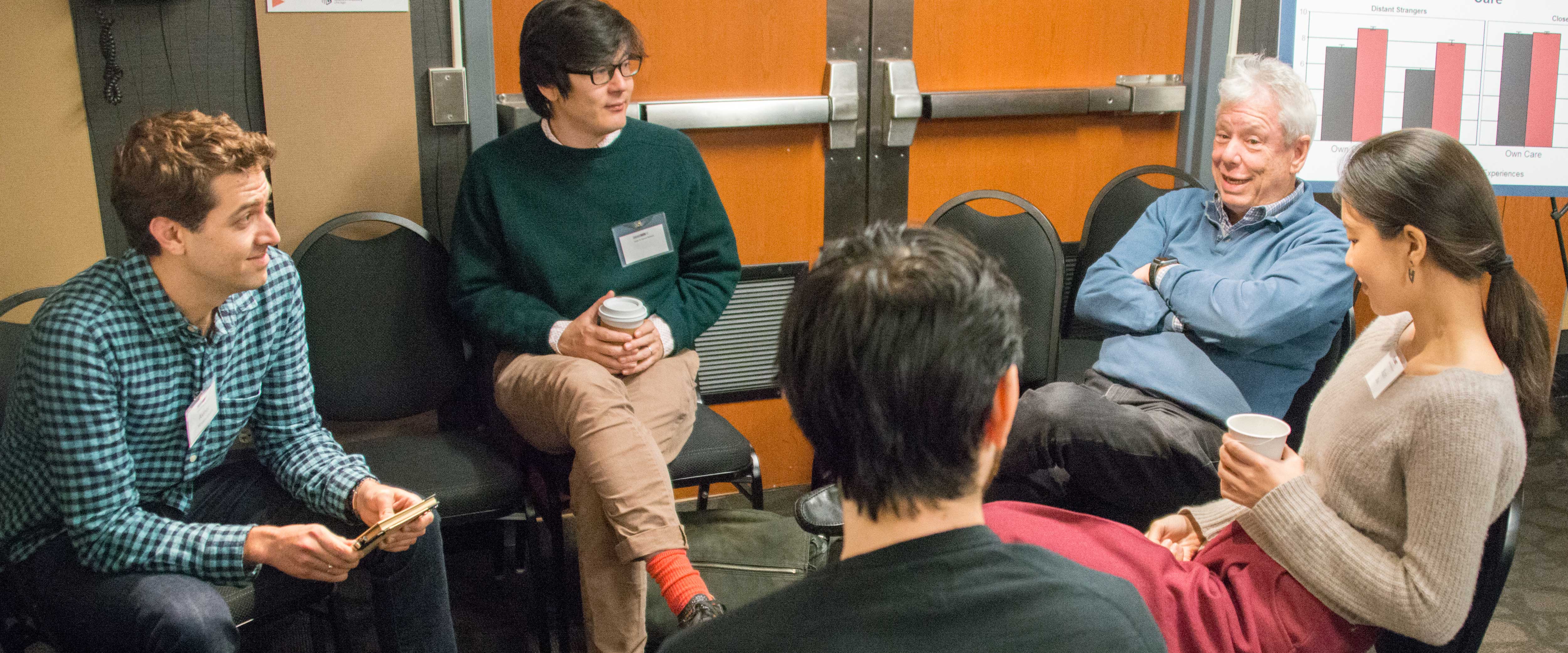 Richard Thaler talking with a group of students at a retreat