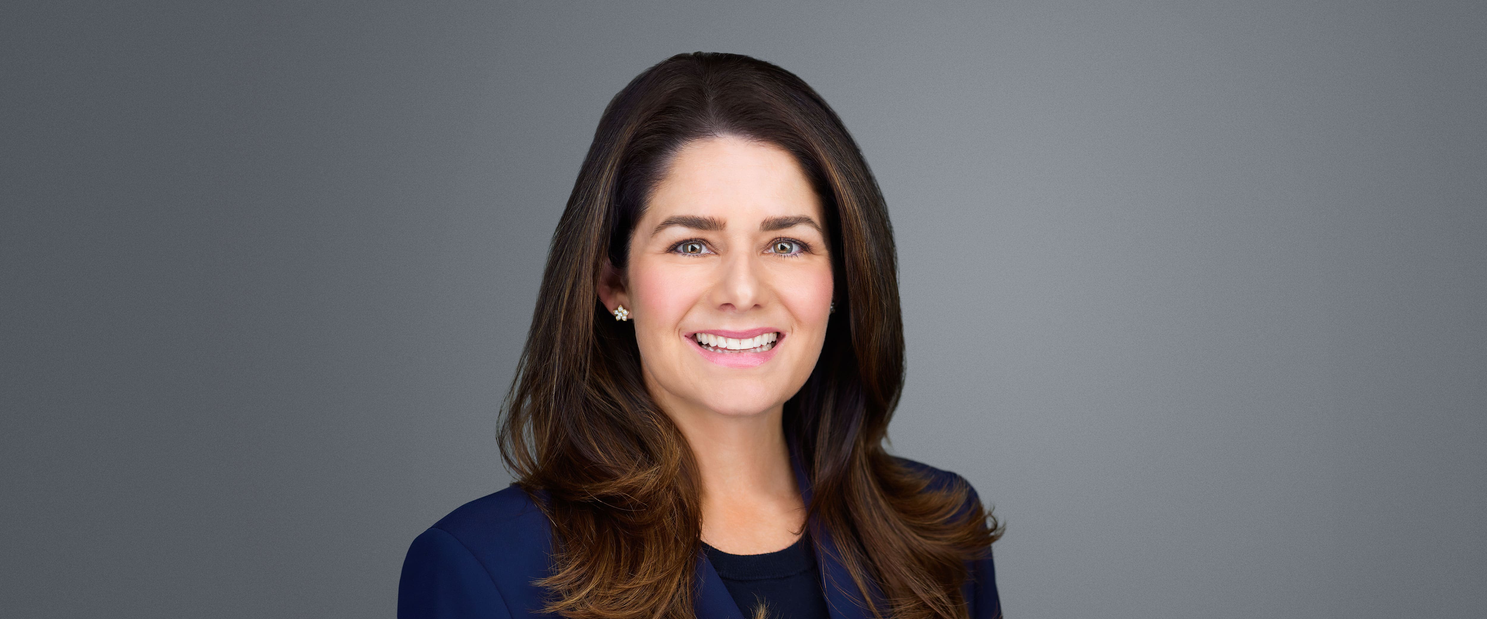 Cindy McGee smiling against grey background