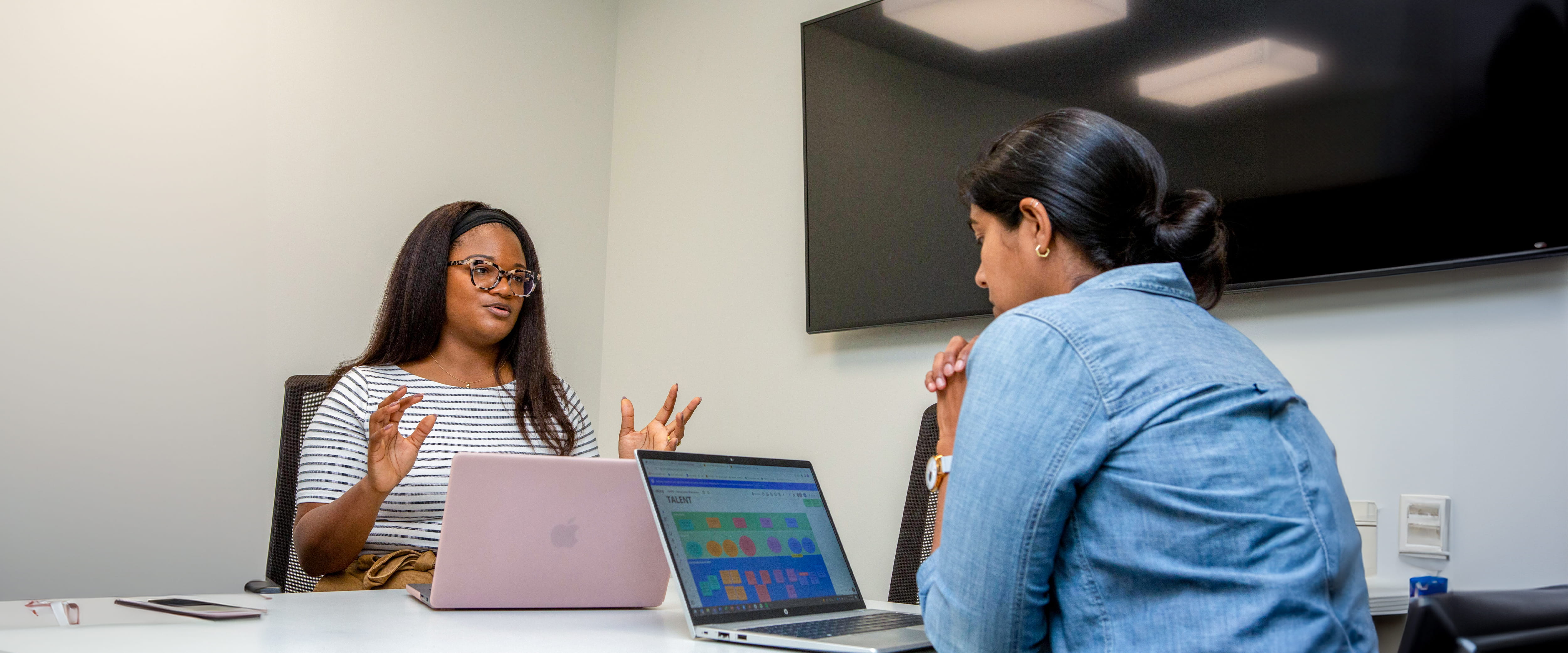 Two students in a room working 