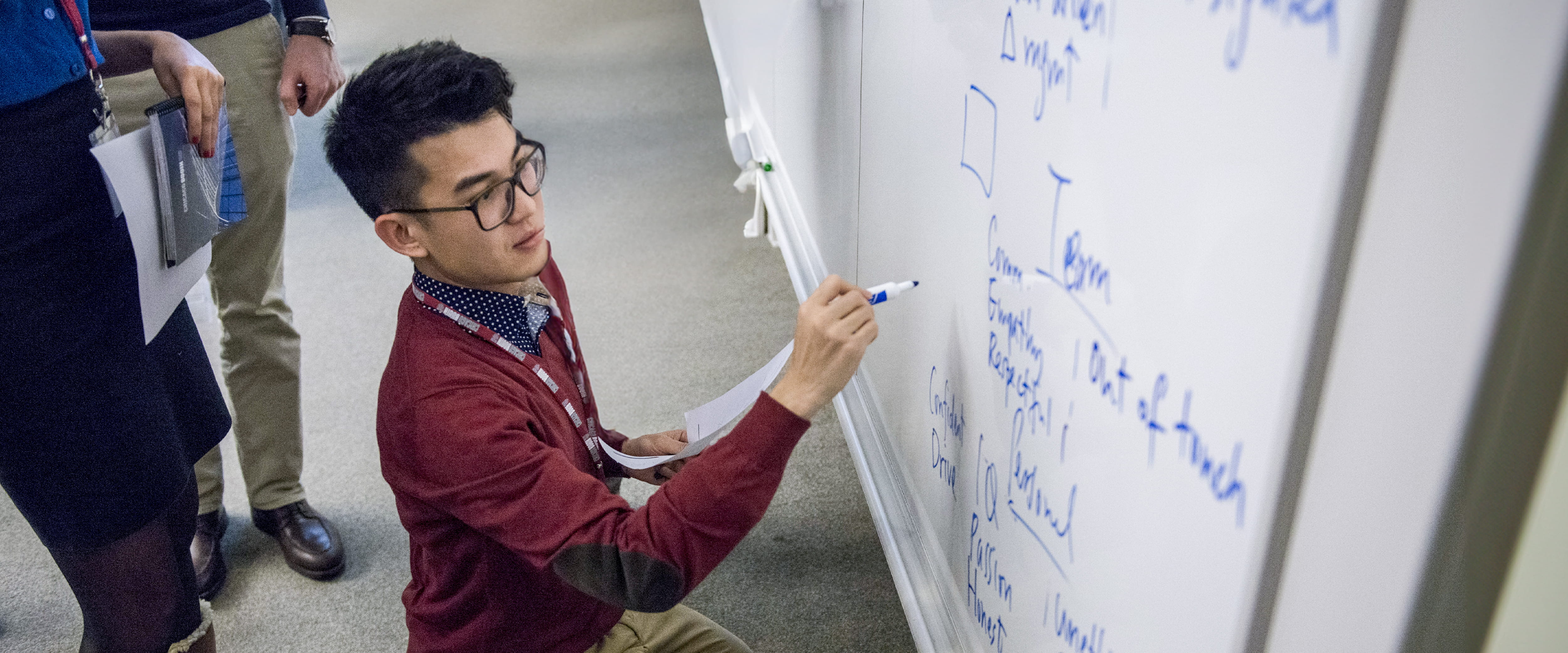 Person drawing on a dry board. 