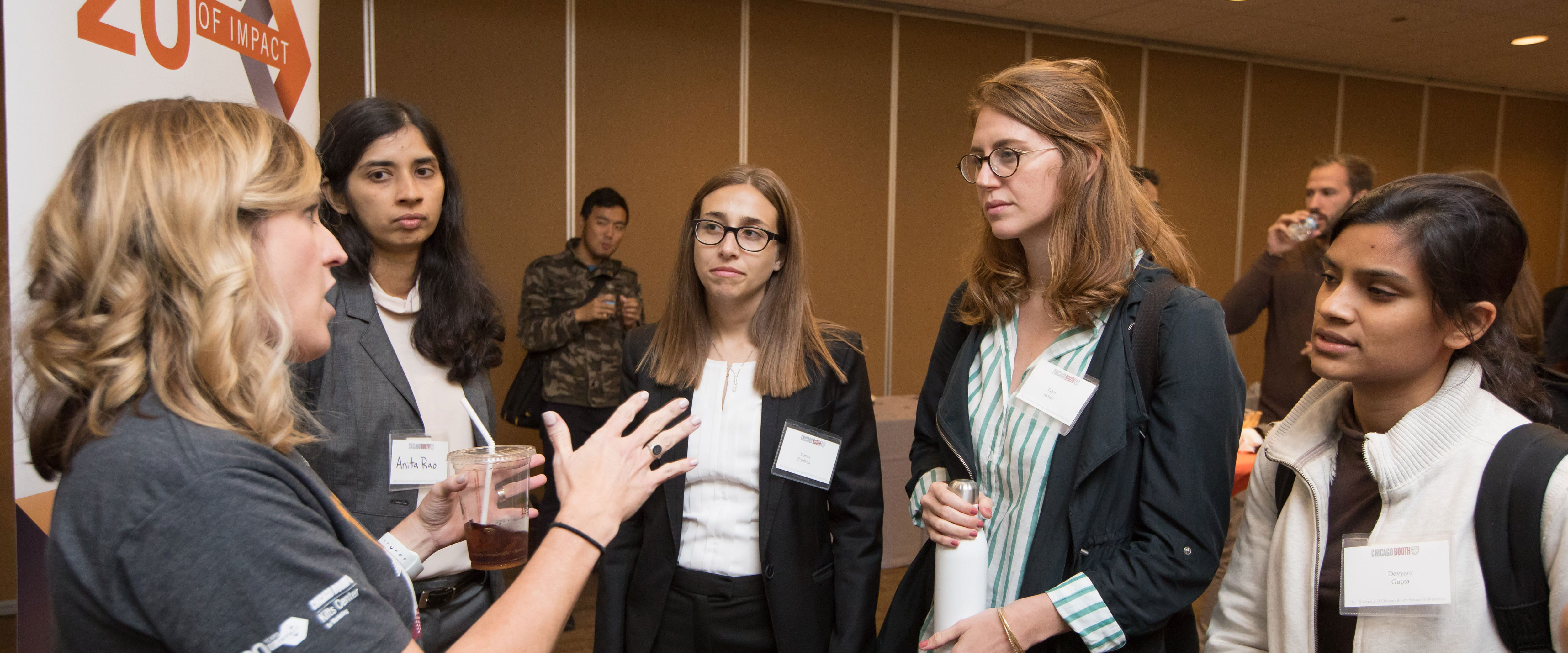 Students in a group talking at Kilts 20th anniversary event