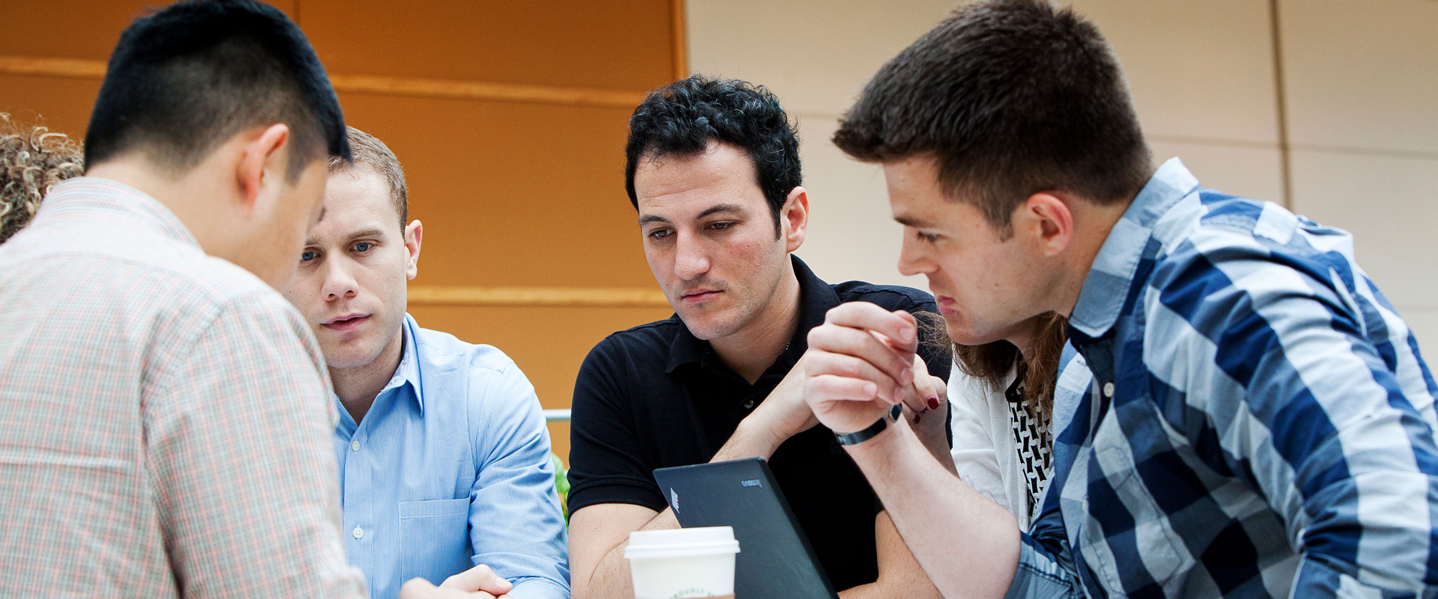 Group of male students working together on a project