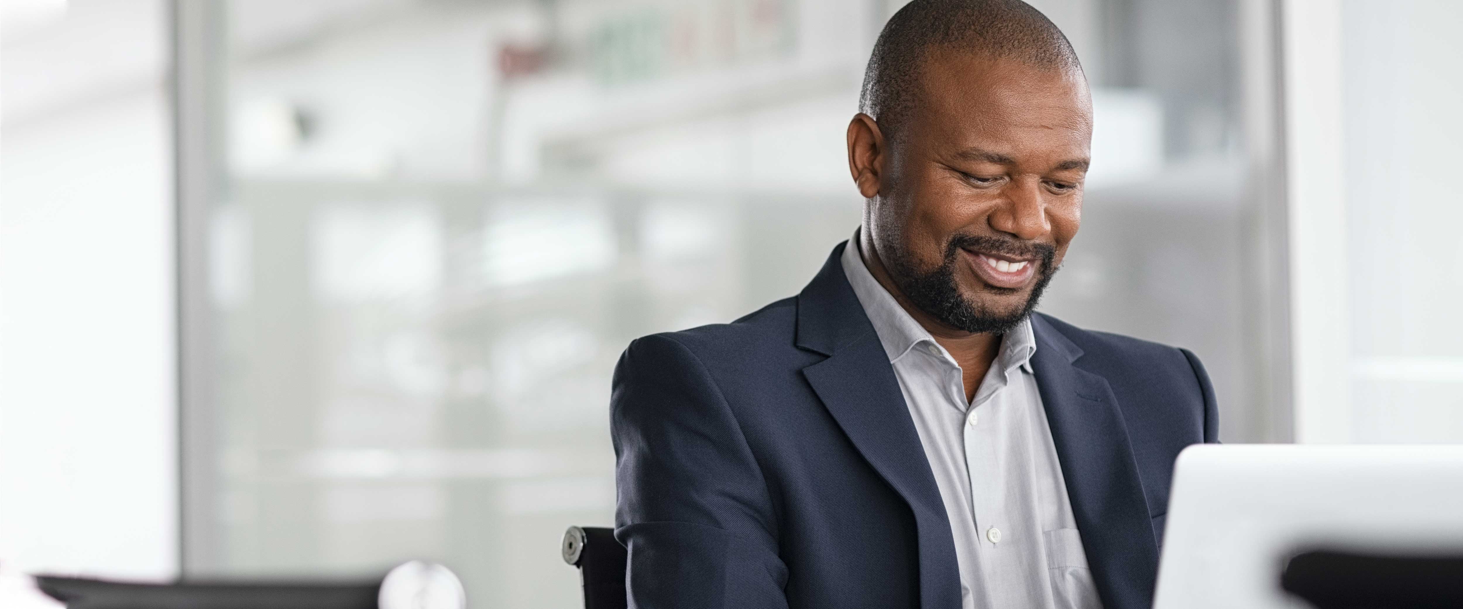 Man on a laptop smiling