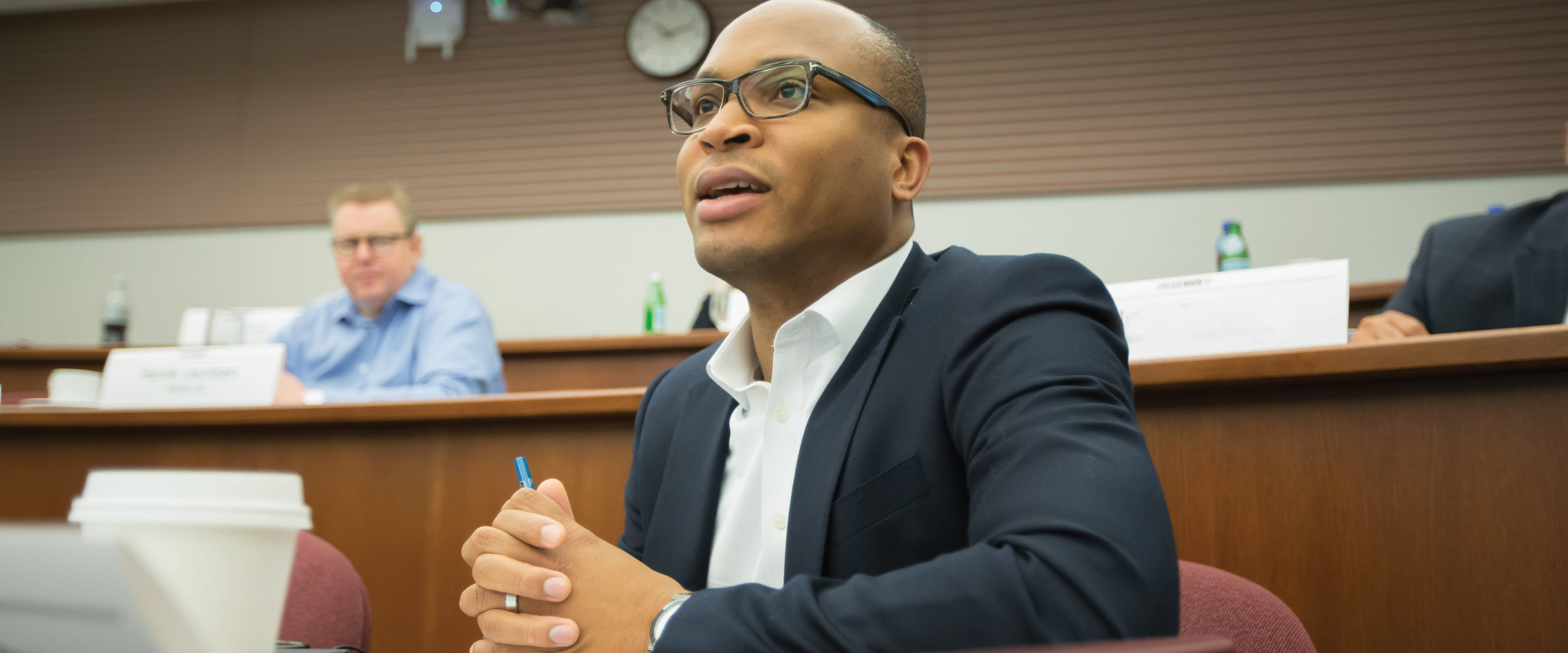 Male student in class speaking to someone off camera