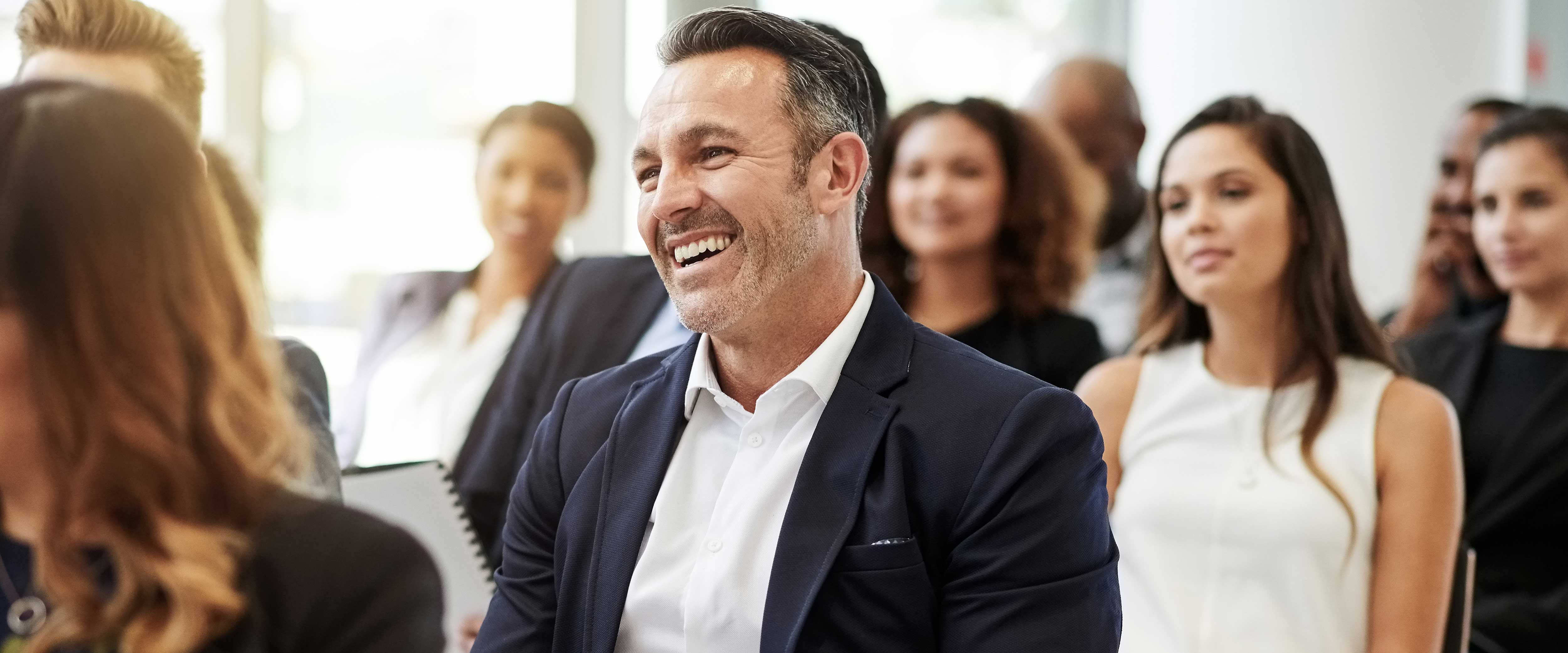 Man in a presentation listening and smiling