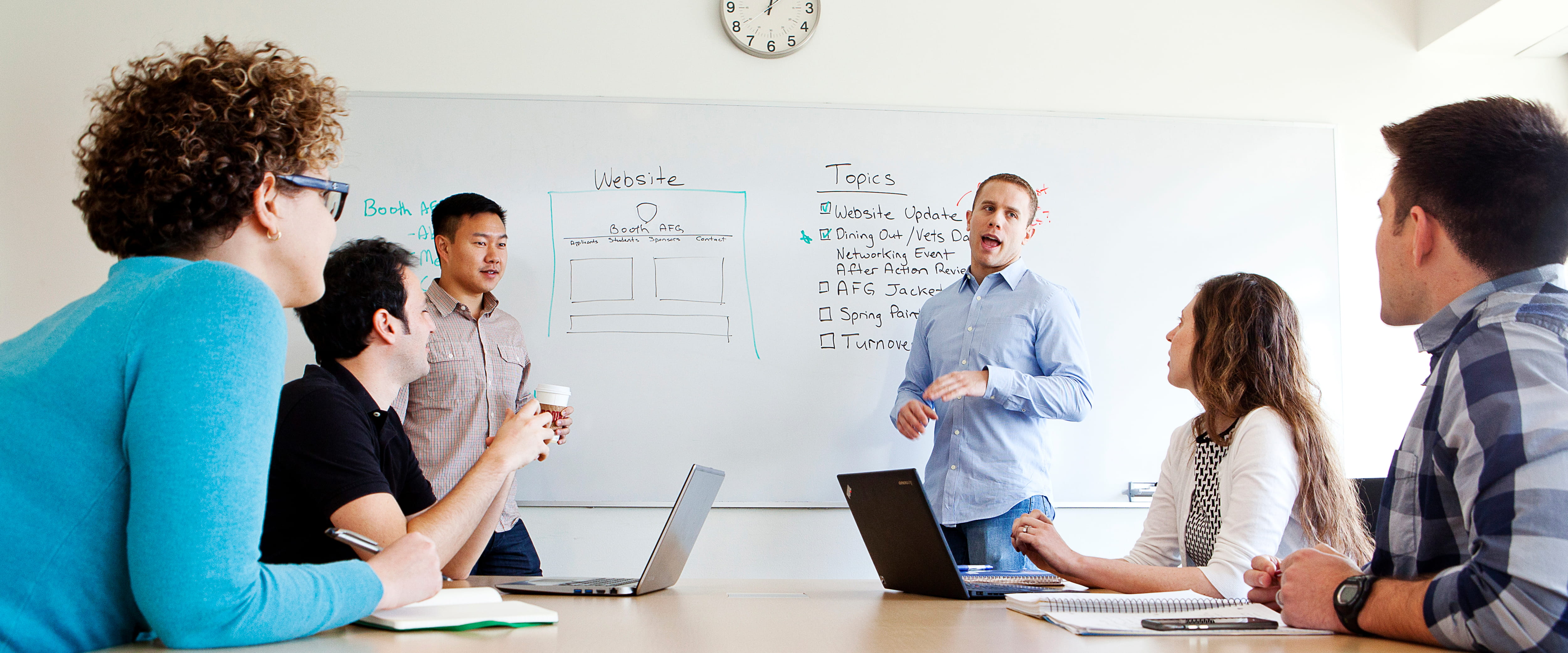 Students participate in a Chicago Booth Armed Forces student group meeting at the Harper Center