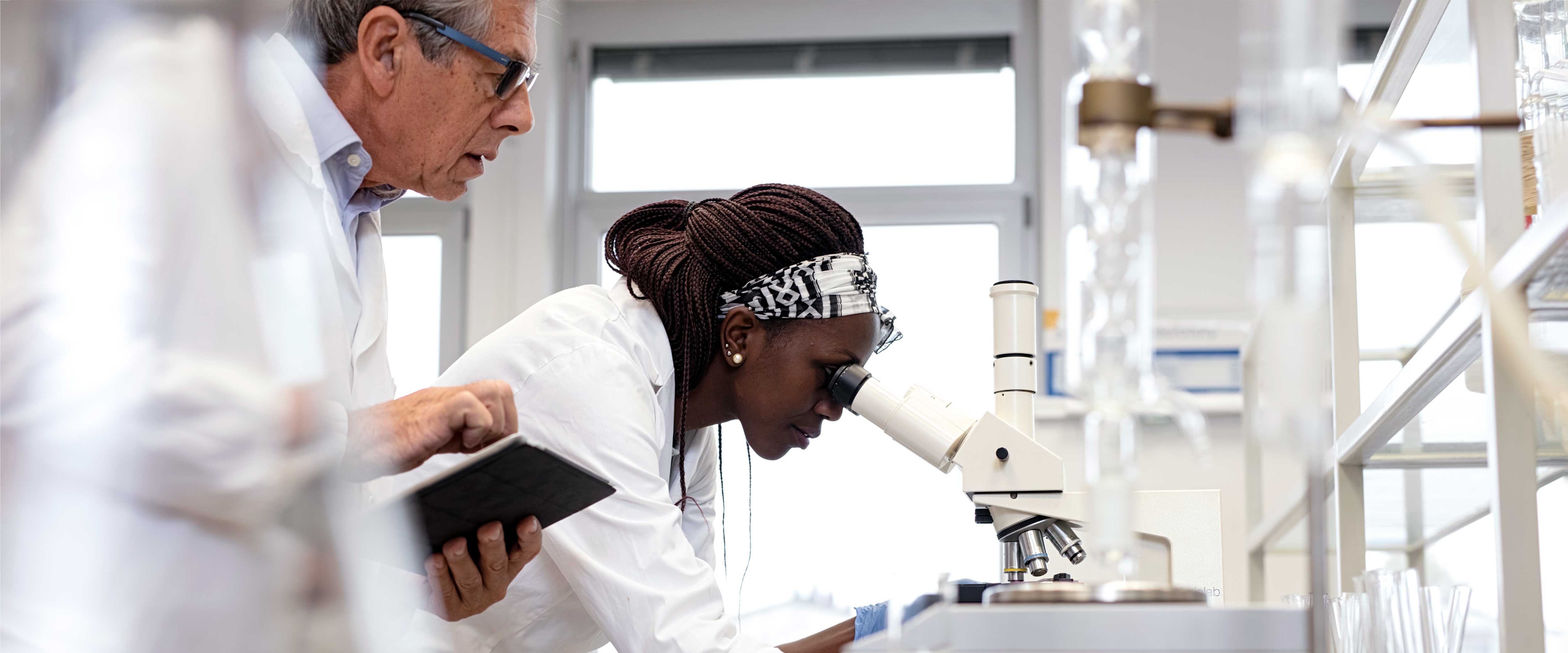 Two people working in a biomedical science lab