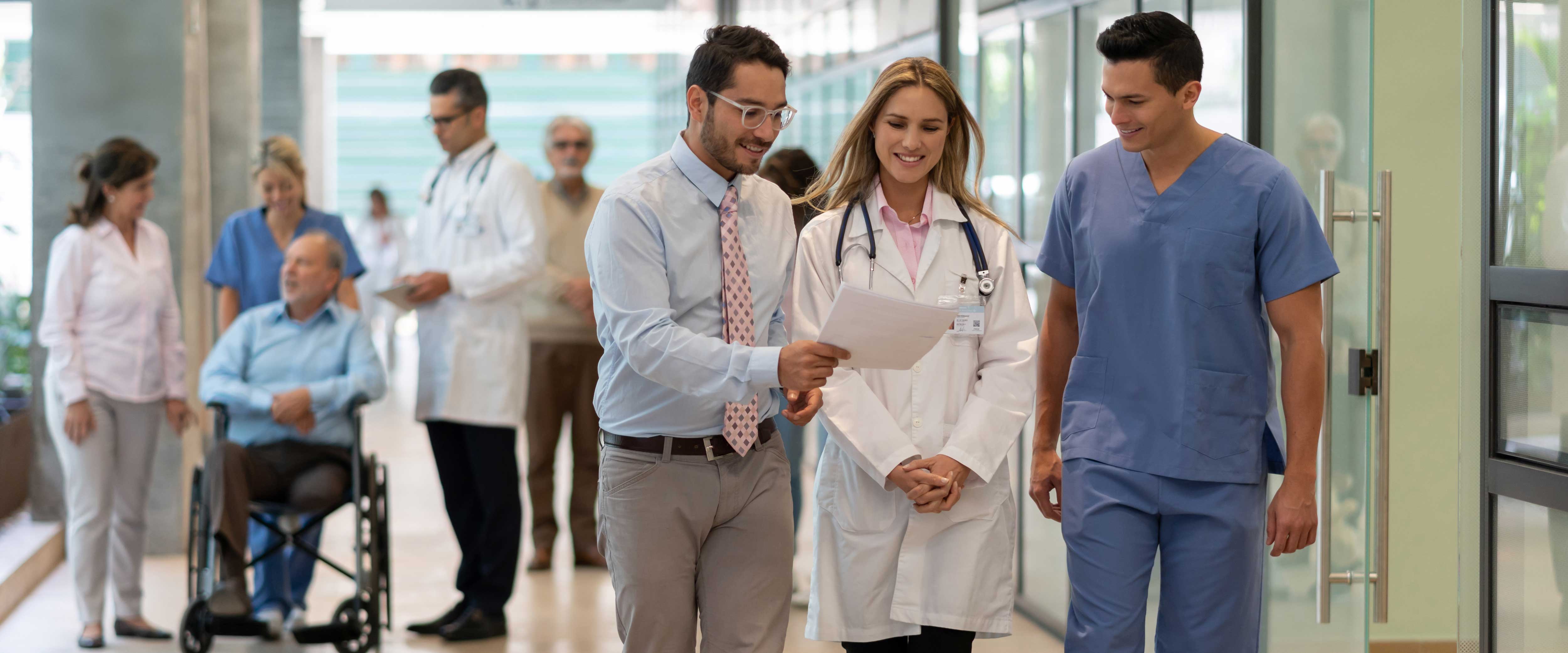 Medical professionals walking down the hallway of a hospital