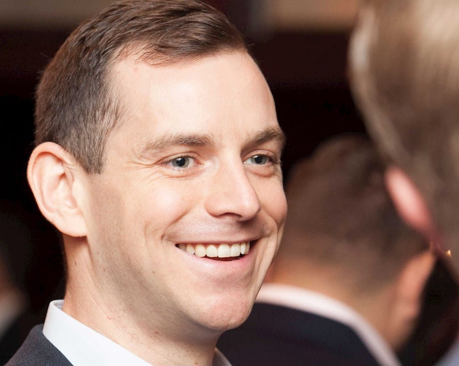 Man at an admissions event speaking to another man