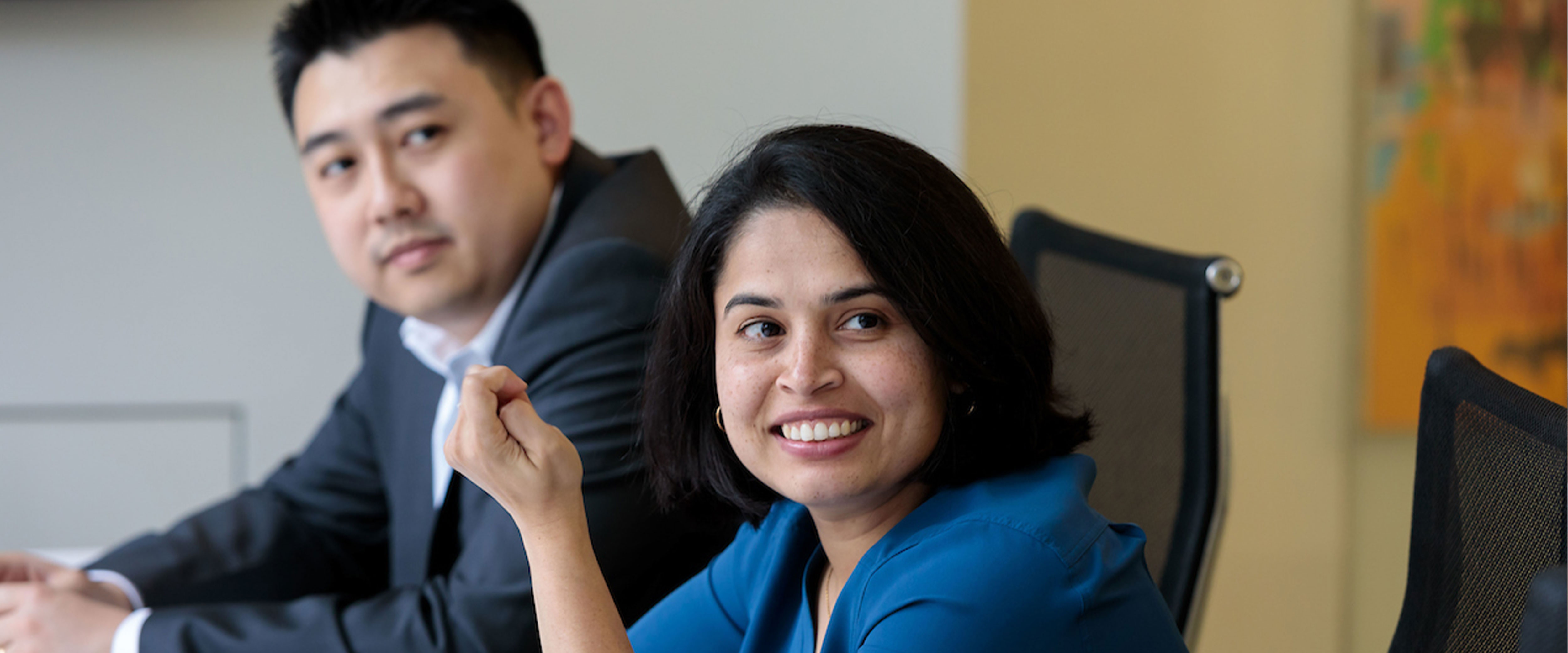 Female and male student listening, in a meeting