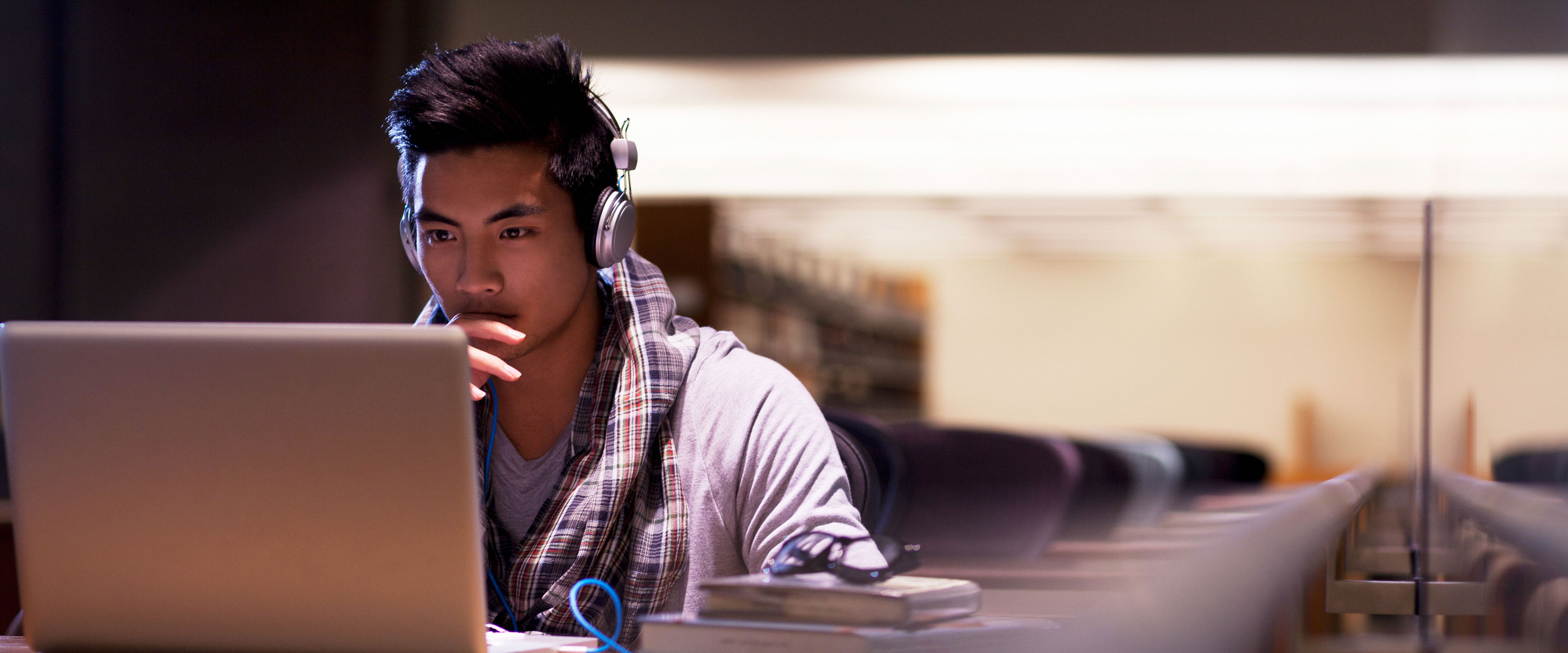 Man in the library on the computer