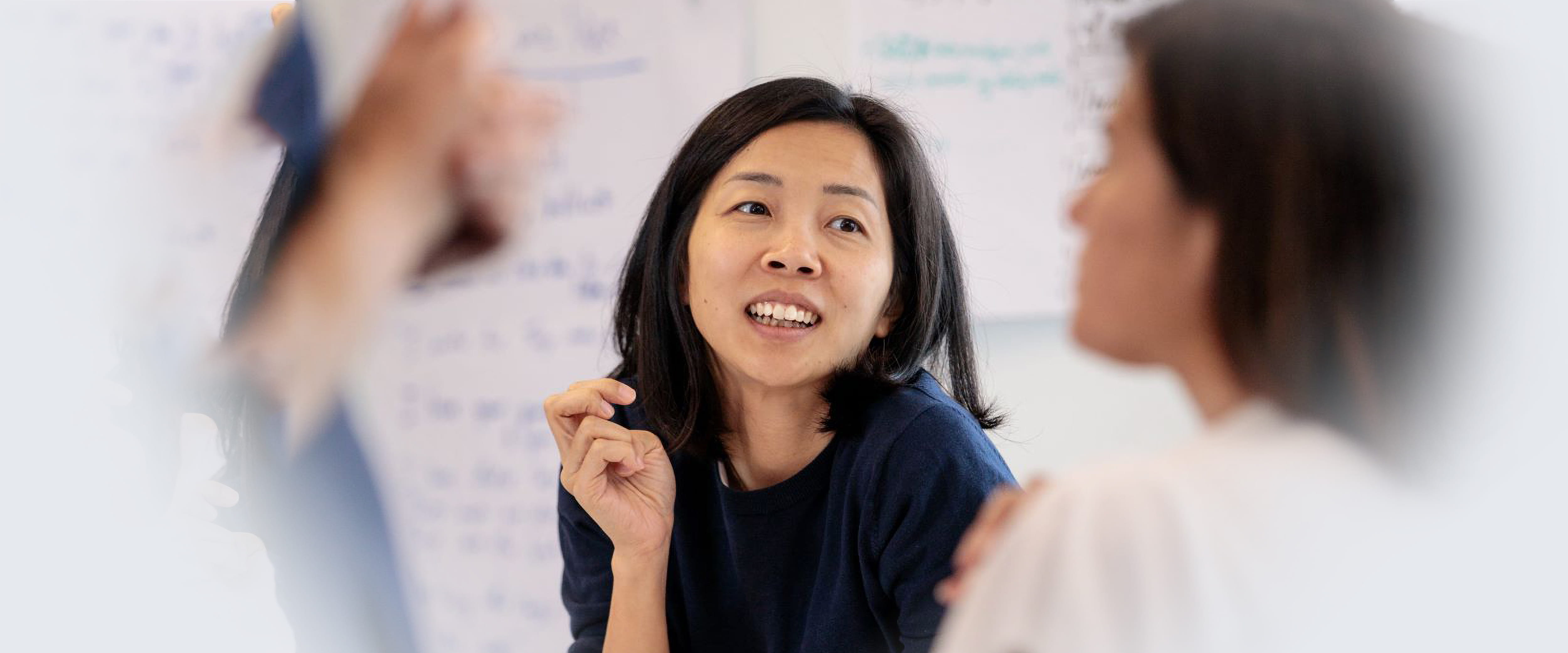 Group lecture and one woman is raising her hand