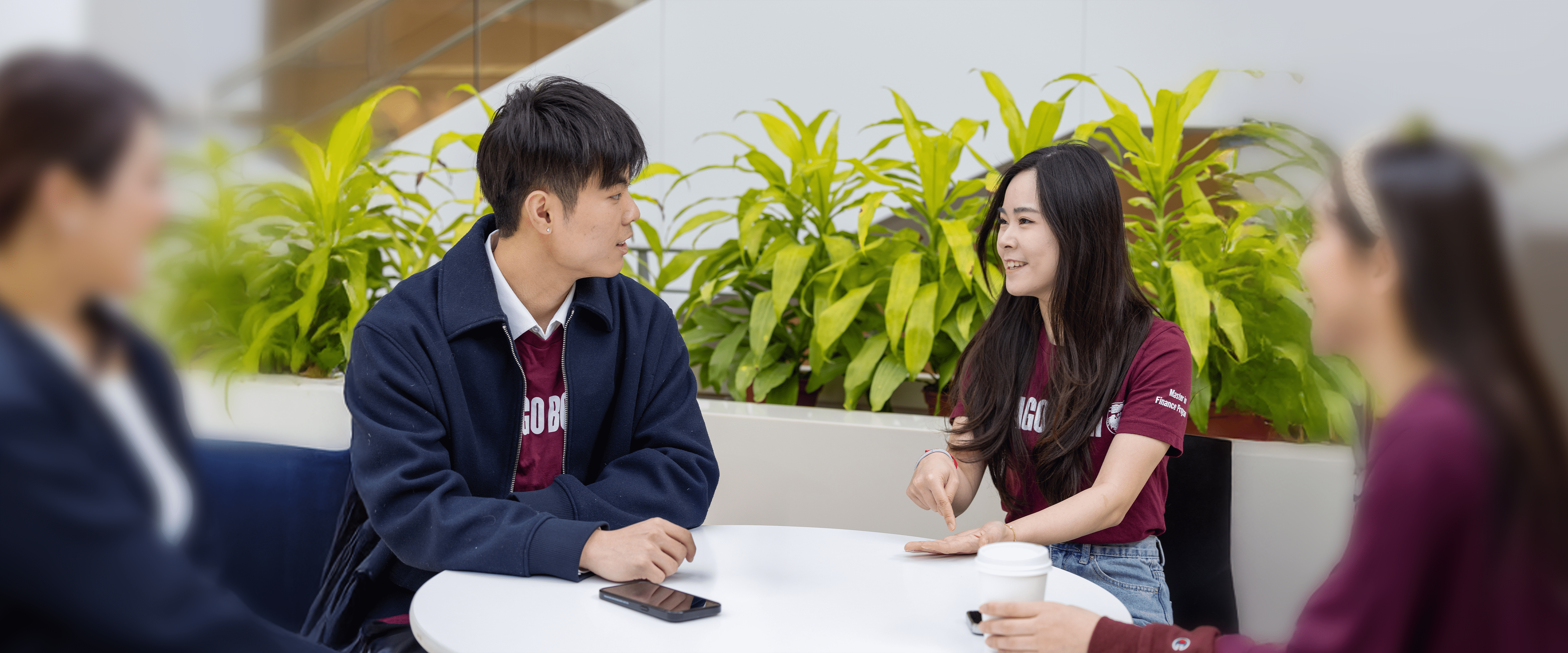 A group of students talking around a table.